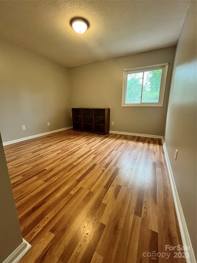 140 Lake Concord Rd NE Unit B7, Concord, NC 28025 - unfurnished room with wood finished floors and a textured ceiling