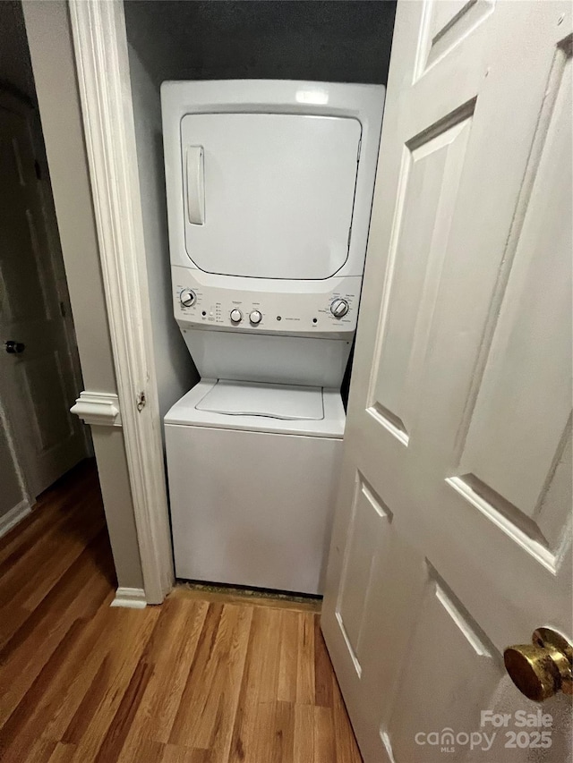 140 Lake Concord Rd NE Unit B7, Concord, NC 28025 - laundry room featuring stacked washer and clothes dryer and wood finished floors