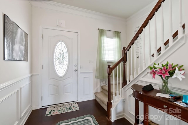 2932 Berry Creek Rd, Charlotte, NC 28214 - entryway with a decorative wall, stairway, crown molding, a wainscoted wall, and dark wood-type flooring