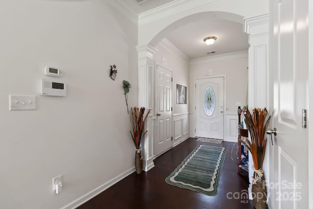 2932 Berry Creek Rd, Charlotte, NC 28214 - foyer with decorative columns, arched walkways, ornamental molding, and dark wood-type flooring