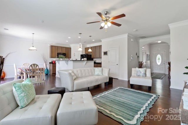 2932 Berry Creek Rd, Charlotte, NC 28214 - living area with ceiling fan, crown molding, dark wood finished floors, arched walkways, and recessed lighting