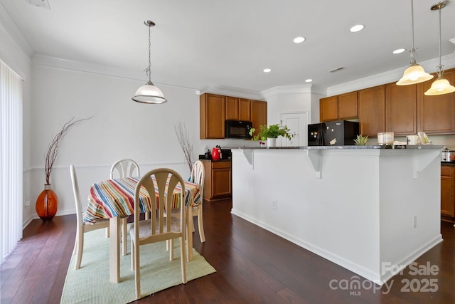 2932 Berry Creek Rd, Charlotte, NC 28214 - kitchen with black appliances, brown cabinetry, recessed lighting, a kitchen breakfast bar, and crown molding