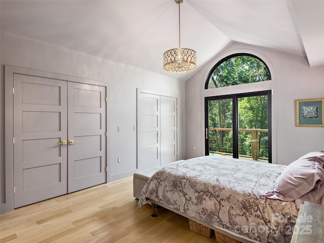 184 Sandys Home Pl, Mars Hill, NC 28754 - bedroom with light wood-type flooring, lofted ceiling, a chandelier, access to exterior, and multiple closets