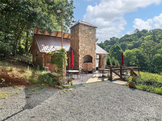 184 Sandys Home Pl, Mars Hill, NC 28754 - rear view of property featuring a standing seam roof, a metal roof, a patio area, a chimney, and a fireplace