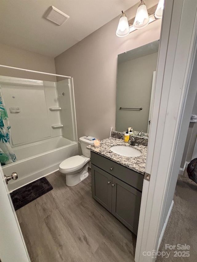 408 E 22nd St, Kannapolis, NC 28083 - full bathroom featuring vanity, shower / bath combo with shower curtain, and wood finished floors
