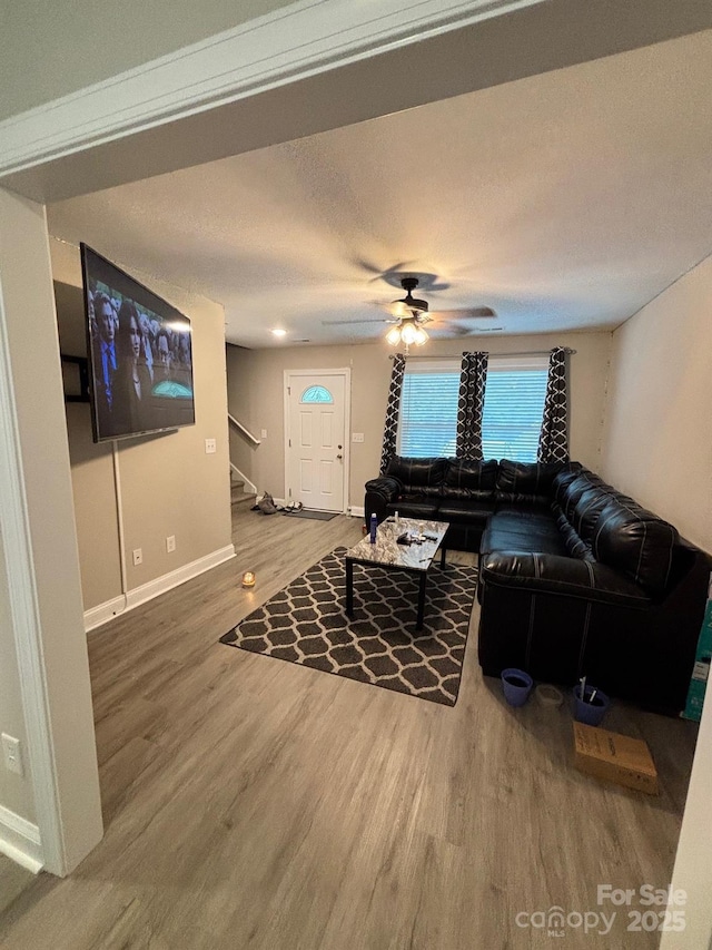 408 E 22nd St, Kannapolis, NC 28083 - living room with stairs, wood finished floors, ceiling fan, and a textured ceiling