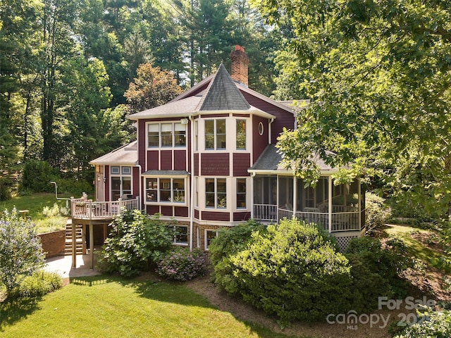 599 Red Fox Ln, Flat Rock, NC 28731 - back of property with a sunroom, stairway, a shingled roof, a chimney, and a wooden deck