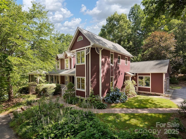 599 Red Fox Ln, Flat Rock, NC 28731 - view of front of home with a front yard, a shingled roof, and driveway
