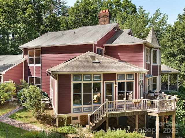 599 Red Fox Ln, Flat Rock, NC 28731 - rear view of property featuring a deck, a sunroom, a chimney, stairway, and a shingled roof