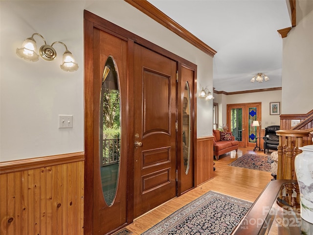 599 Red Fox Ln, Flat Rock, NC 28731 - entrance foyer featuring a wainscoted wall, wood finished floors, ornamental molding, and wood walls