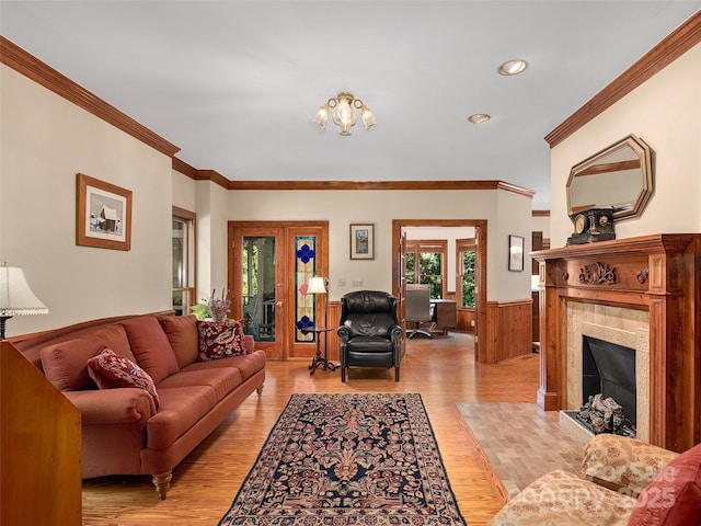 599 Red Fox Ln, Flat Rock, NC 28731 - living room featuring a tiled fireplace, light wood-type flooring, wainscoting, crown molding, and recessed lighting