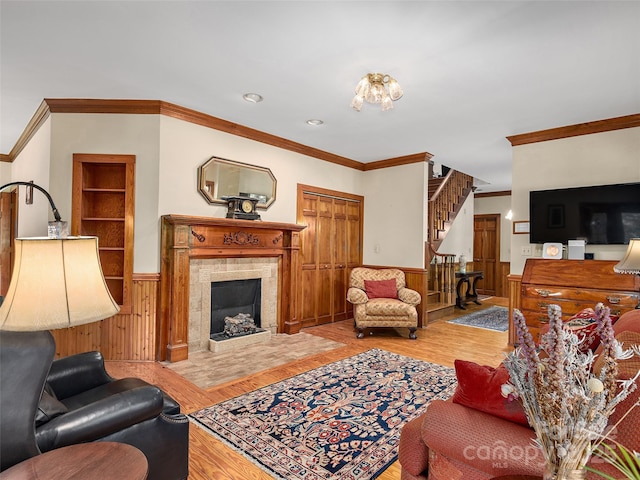 599 Red Fox Ln, Flat Rock, NC 28731 - living area with a wainscoted wall, crown molding, stairway, wood finished floors, and a tile fireplace