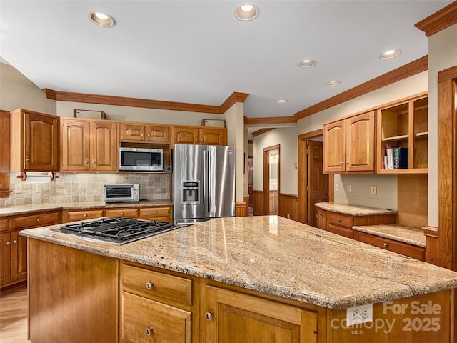 599 Red Fox Ln, Flat Rock, NC 28731 - kitchen with stainless steel appliances, light stone countertops, a kitchen island, ornamental molding, and decorative backsplash