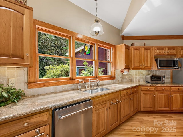 599 Red Fox Ln, Flat Rock, NC 28731 - kitchen featuring appliances with stainless steel finishes, lofted ceiling, light wood-style flooring, light stone counters, and hanging light fixtures