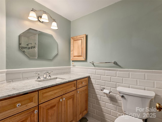 599 Red Fox Ln, Flat Rock, NC 28731 - full bathroom with a wainscoted wall, vanity, tile walls, and a shower