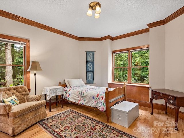 599 Red Fox Ln, Flat Rock, NC 28731 - bedroom with ornamental molding, hardwood / wood-style flooring, and a textured ceiling
