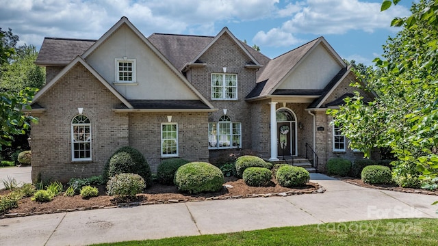 2301 Willow Creek Dr, Newton, NC 28658 - view of front of home with stucco siding, brick siding, and a shingled roof