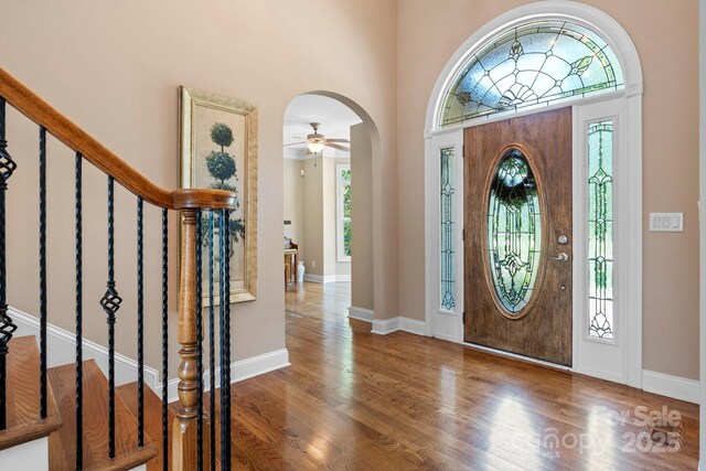 2301 Willow Creek Dr, Newton, NC 28658 - entryway with arched walkways, wood finished floors, stairs, a towering ceiling, and a ceiling fan
