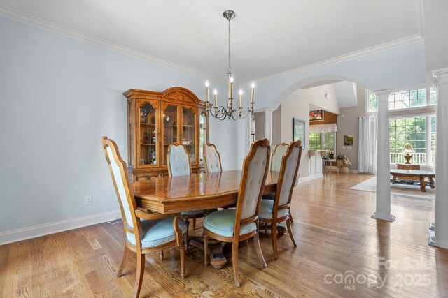 2301 Willow Creek Dr, Newton, NC 28658 - dining area featuring decorative columns, arched walkways, ornamental molding, and light wood-style floors