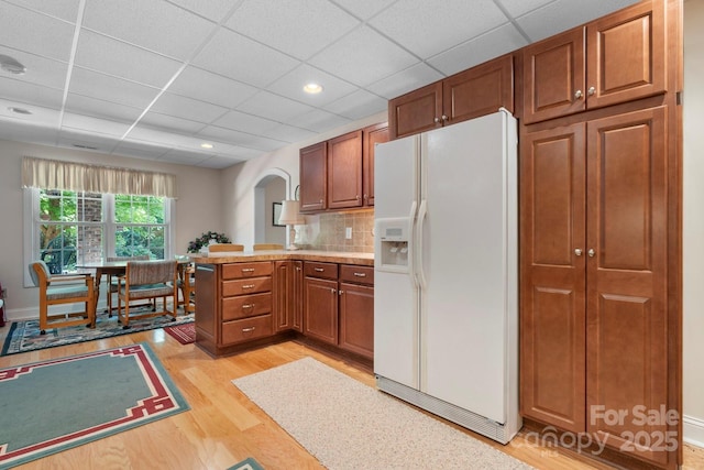 2301 Willow Creek Dr, Newton, NC 28658 - kitchen with white fridge with ice dispenser, light wood-type flooring, a peninsula, a drop ceiling, and brown cabinetry