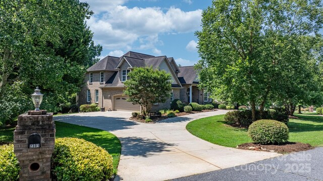 2301 Willow Creek Dr, Newton, NC 28658 - view of front of property featuring concrete driveway, an attached garage, brick siding, and a front yard