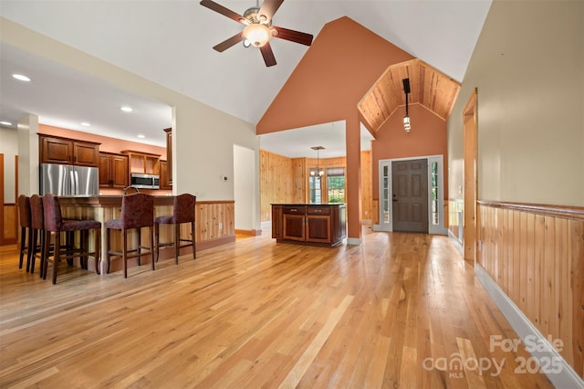 60 Bridge Ln, Tryon, NC 28782 - living area with a ceiling fan, high vaulted ceiling, light wood-style flooring, wooden walls, and recessed lighting