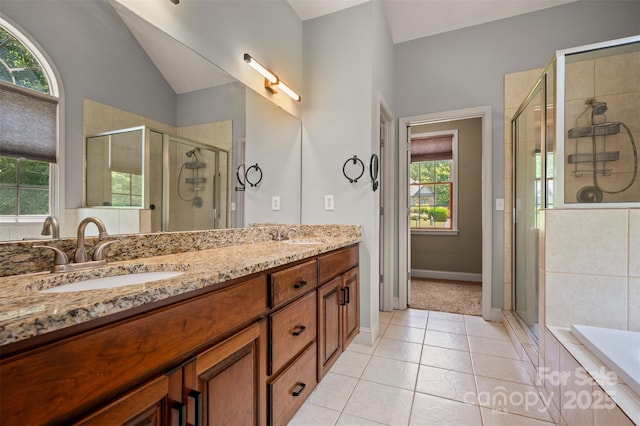 60 Bridge Ln, Tryon, NC 28782 - full bathroom featuring plenty of natural light, double vanity, vaulted ceiling, and a shower stall