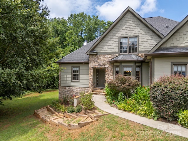 60 Bridge Ln, Tryon, NC 28782 - craftsman-style house featuring stone siding, a front lawn, and a shingled roof