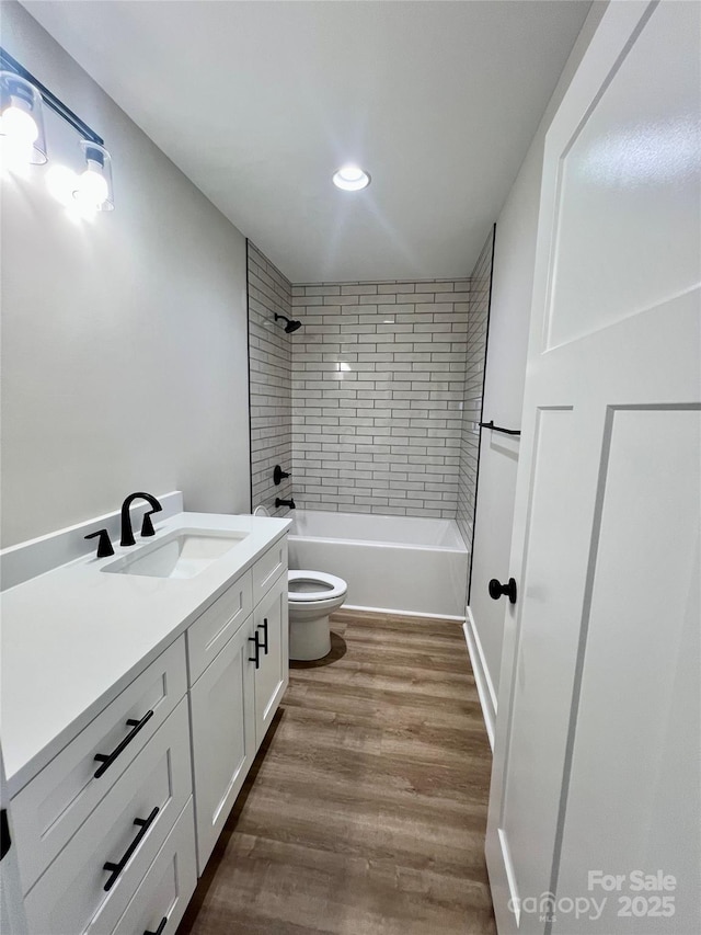 234 W Vance St, China Grove, NC 28023 - bathroom featuring vanity, recessed lighting, wood finished floors, and washtub / shower combination