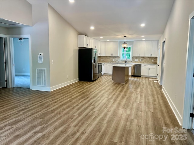 234 W Vance St, China Grove, NC 28023 - kitchen with appliances with stainless steel finishes, light wood-style floors, white cabinetry, and recessed lighting