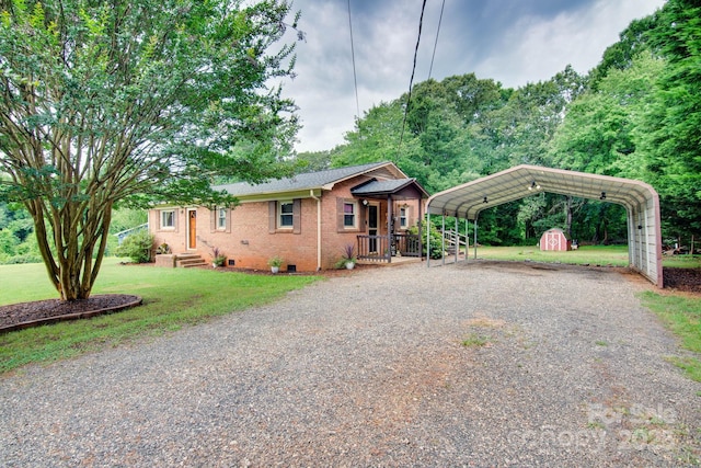 1715 Nelson Dr, Newton, NC 28658 - view of front of home featuring a storage shed, driveway, a detached carport, a front yard, and brick siding