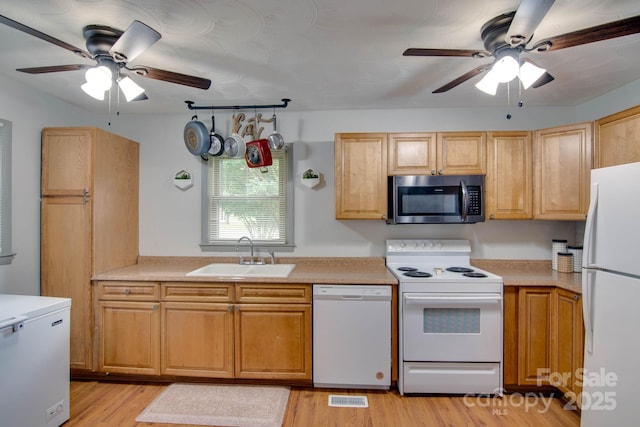 1715 Nelson Dr, Newton, NC 28658 - kitchen with white appliances, ceiling fan, light wood-type flooring, and light countertops