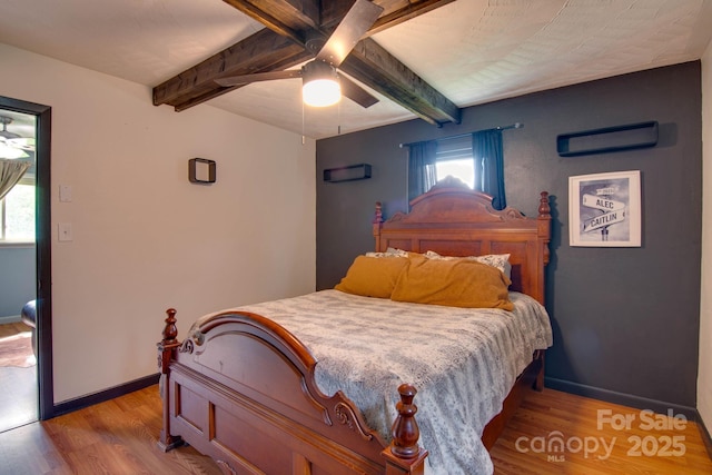 1715 Nelson Dr, Newton, NC 28658 - bedroom with beam ceiling, light wood-style floors, and a ceiling fan