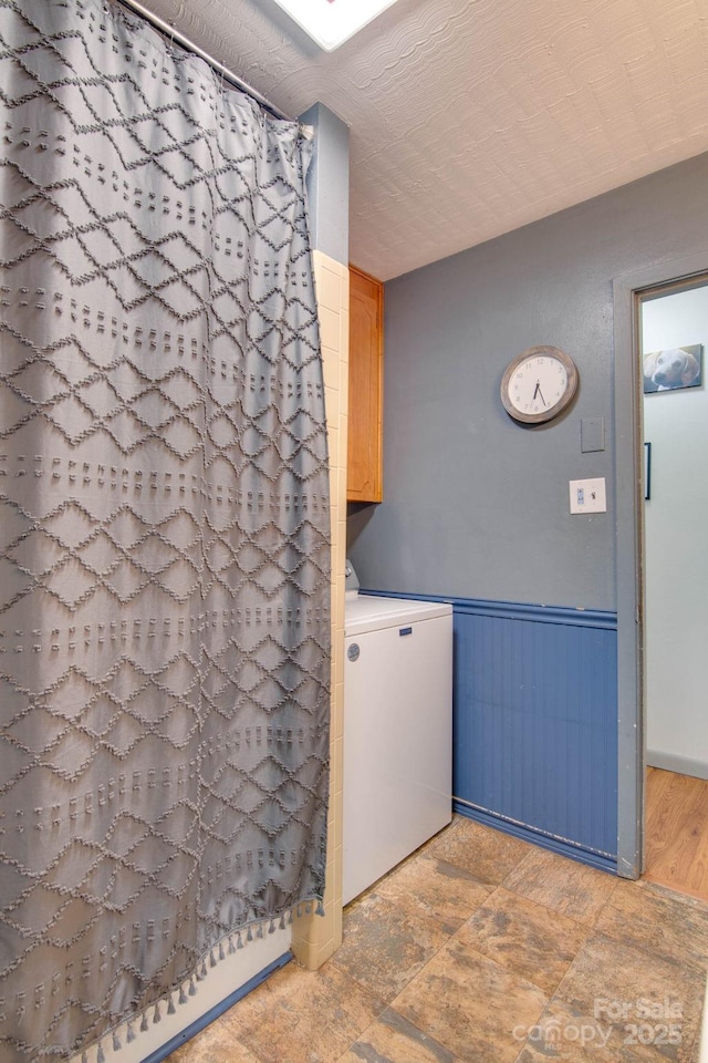 1715 Nelson Dr, Newton, NC 28658 - bathroom with washer / clothes dryer, wainscoting, and curtained shower