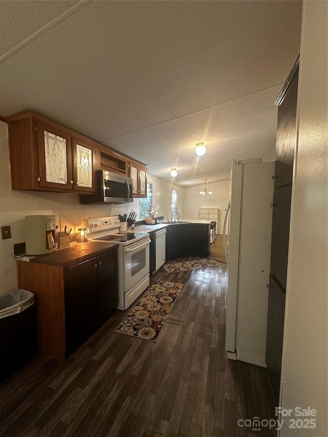 584 Ebenezer Rd, Old Fort, NC 28762 - kitchen featuring white appliances, a peninsula, dark wood-type flooring, and a textured ceiling