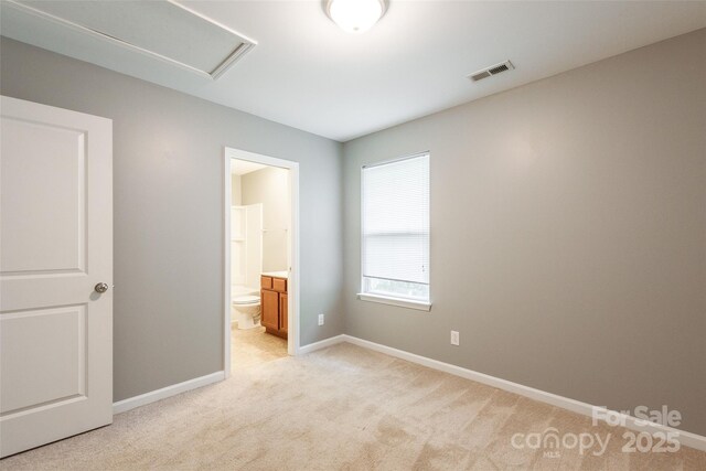 8225 Midas Ln, Locust, NC 28097 - unfurnished bedroom with light carpet, ensuite bathroom, and attic access