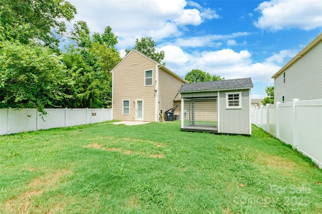 8225 Midas Ln, Locust, NC 28097 - back of property featuring a fenced backyard and a storage unit