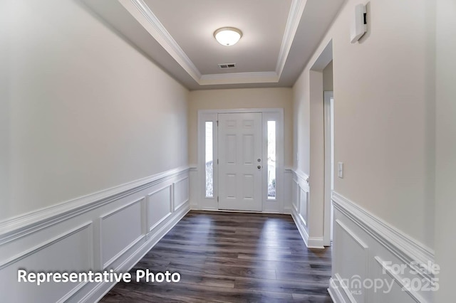 3238 Bozeman Ct Unit 07, Denver, NC 28164 - foyer entrance featuring a decorative wall, ornamental molding, a tray ceiling, dark wood-style flooring, and wainscoting