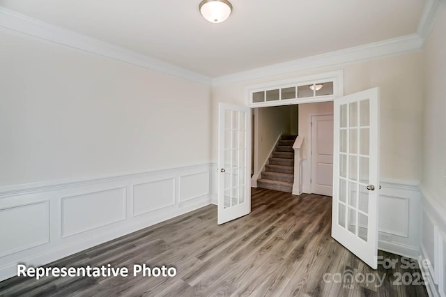 3238 Bozeman Ct Unit 07, Denver, NC 28164 - unfurnished room with french doors, crown molding, a decorative wall, wainscoting, and wood finished floors