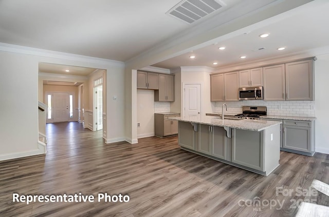 3238 Bozeman Ct Unit 07, Denver, NC 28164 - kitchen featuring appliances with stainless steel finishes, gray cabinetry, ornamental molding, dark wood-type flooring, and backsplash