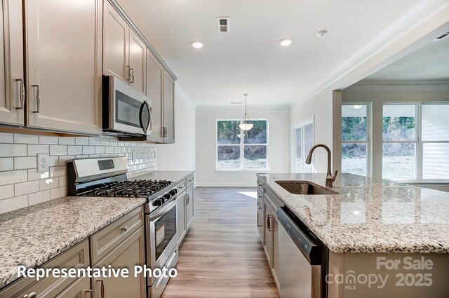 3238 Bozeman Ct Unit 07, Denver, NC 28164 - kitchen with stainless steel appliances, ornamental molding, light wood-style flooring, tasteful backsplash, and gray cabinetry