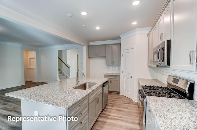 3238 Bozeman Ct Unit 07, Denver, NC 28164 - kitchen featuring stainless steel appliances, crown molding, gray cabinets, light wood-type flooring, and light stone counters