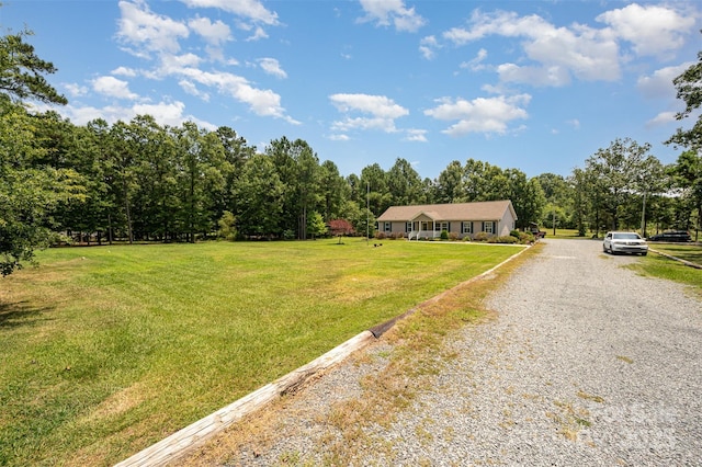 5602 Flint Ridge Church Rd, Marshville, NC 28103 - view of front of home featuring gravel driveway, a front lawn, and a forest view