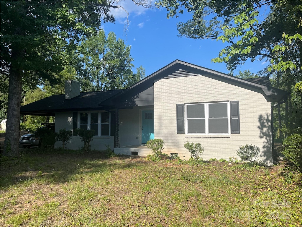 1128 Grady St, Salisbury, NC 28144 - ranch-style house featuring brick siding, a front yard, and a chimney