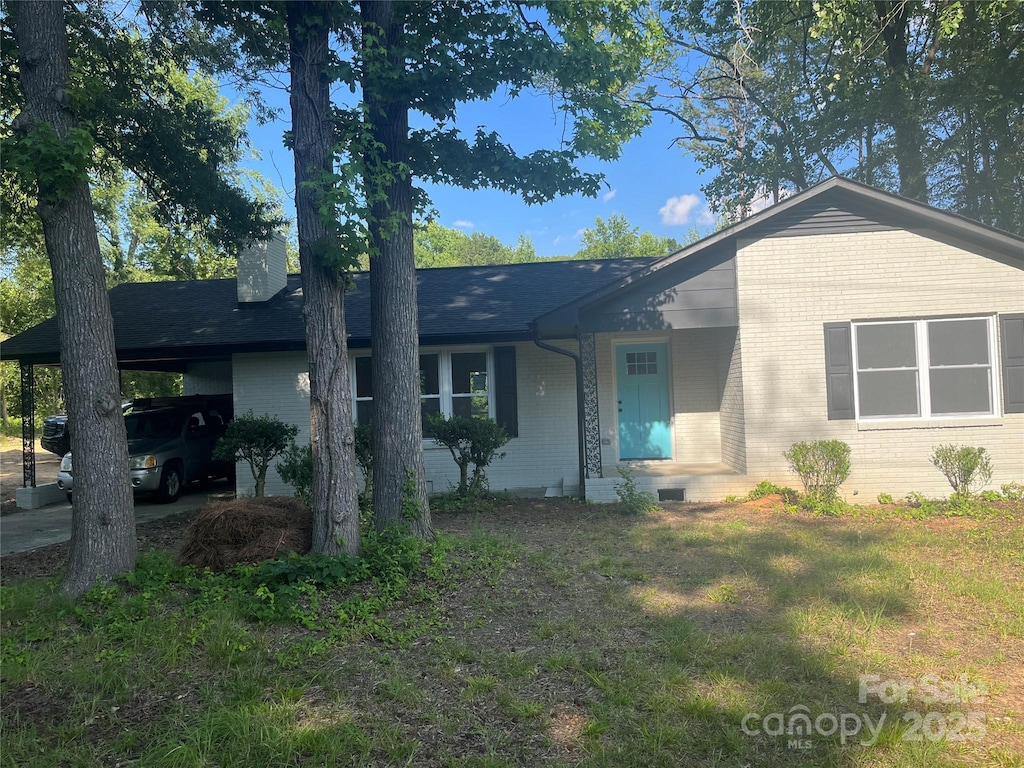 1128 Grady St, Salisbury, NC 28144 - single story home with brick siding, a chimney, and a carport