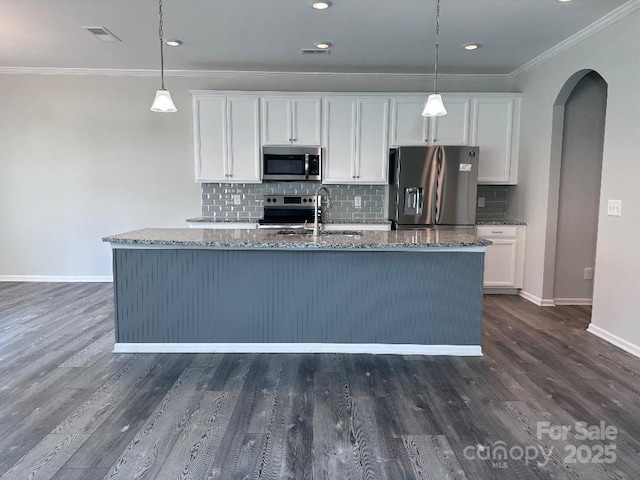 764 River Park Rd, Belmont, NC 28012 - kitchen with stainless steel appliances, arched walkways, ornamental molding, dark stone countertops, and white cabinets