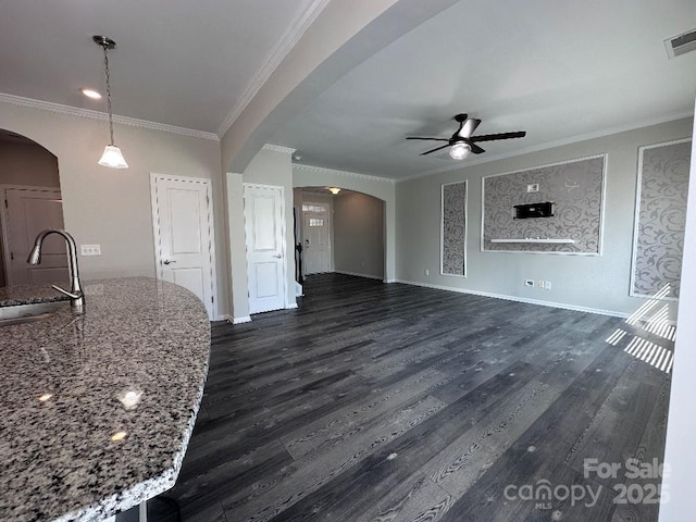 764 River Park Rd, Belmont, NC 28012 - unfurnished living room with arched walkways, a ceiling fan, dark wood-style flooring, and crown molding