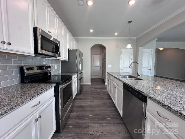 764 River Park Rd, Belmont, NC 28012 - kitchen with appliances with stainless steel finishes, arched walkways, white cabinetry, crown molding, and backsplash