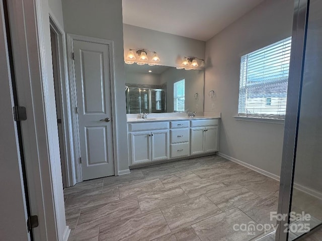 764 River Park Rd, Belmont, NC 28012 - bathroom featuring double vanity, a shower stall, and marble look tile flooring