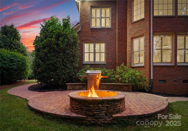 3015 Stanbury Dr, Matthews, NC 28104 - view of side of home with brick siding, an outdoor fire pit, a patio, and crawl space